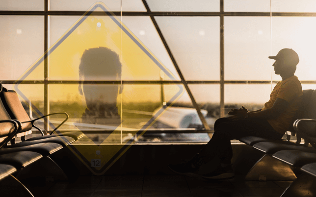 silhouette ofstudent sitting at airport:Beware of Fake Acceptance Letters: A Warning for International Students Applying to Study in Canada